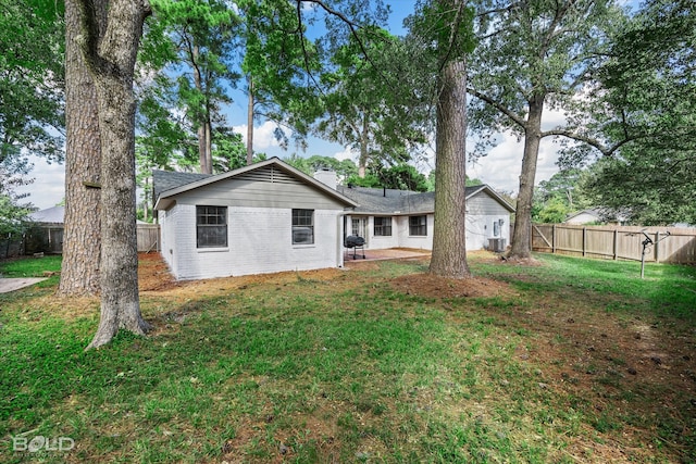 rear view of property with a lawn