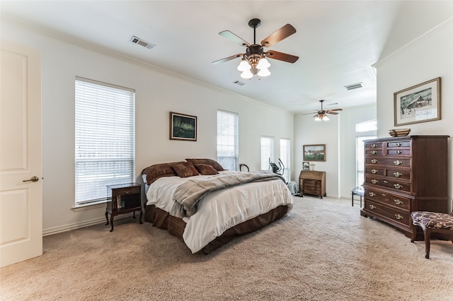 bedroom with crown molding, multiple windows, ceiling fan, and light colored carpet