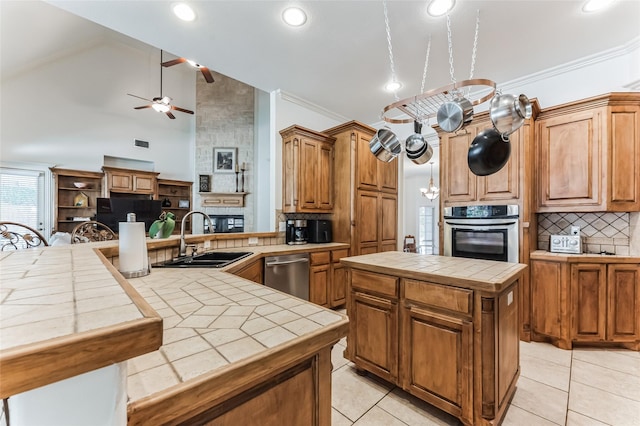 216 Laurel Creek Dr, Sherman, TX 75092 - kitchen featuring stainless steel appliances, tile countertops, ceiling fan, backsplash, and light tile patterned flooring