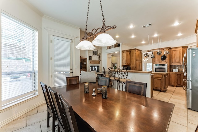 216 Laurel Creek Dr, Sherman, TX 75092 - dining room featuring light tile patterned flooring, crown molding, and a fireplace