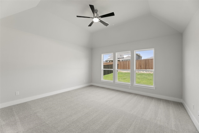 carpeted spare room featuring ceiling fan and vaulted ceiling