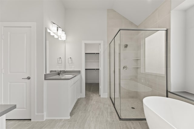 bathroom with shower with separate bathtub, vanity, and tile patterned floors