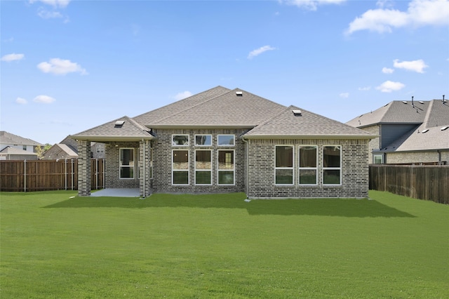 back of property featuring a lawn and a patio