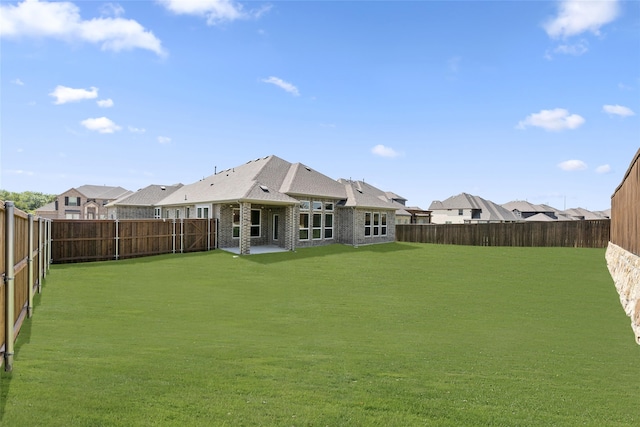 rear view of property featuring a lawn