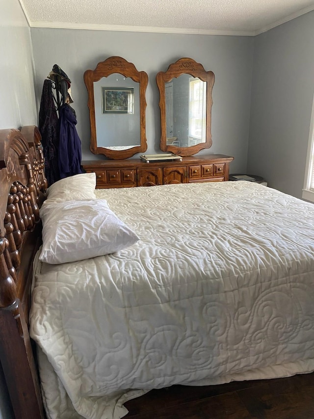 bedroom featuring a textured ceiling and ornamental molding