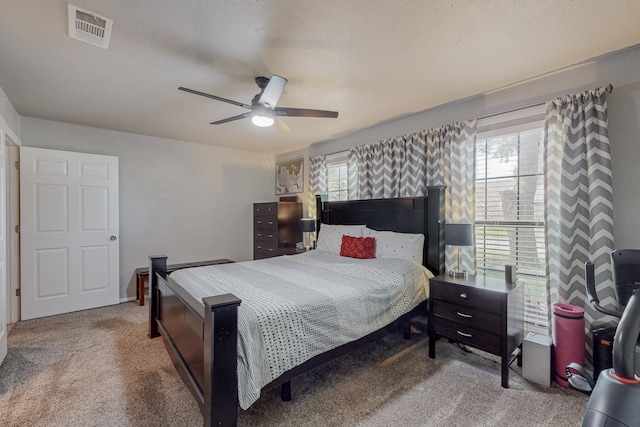 bedroom featuring carpet flooring, multiple windows, and ceiling fan