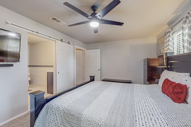 bedroom featuring carpet flooring, ceiling fan, and ensuite bath