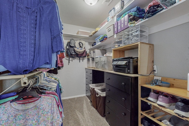 walk in closet with carpet flooring