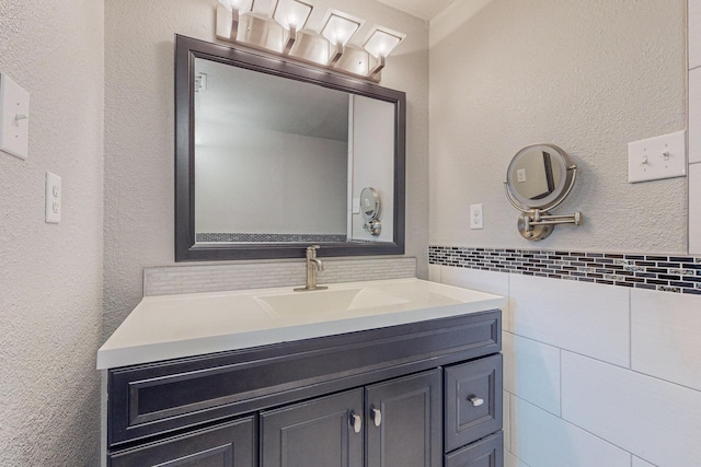 bathroom with vanity and tile walls