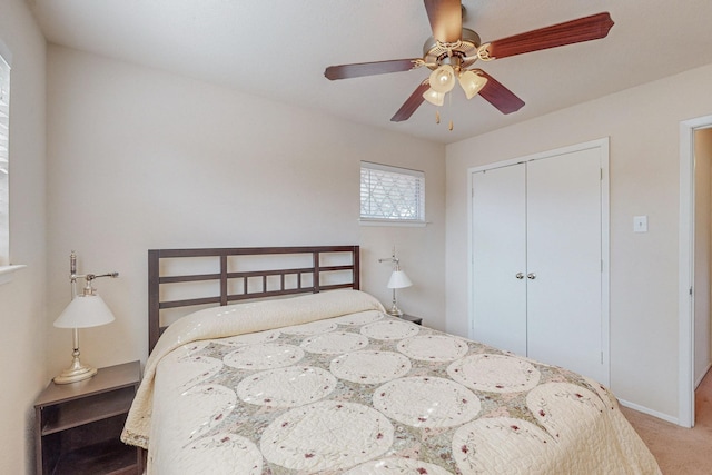 carpeted bedroom with a closet and ceiling fan