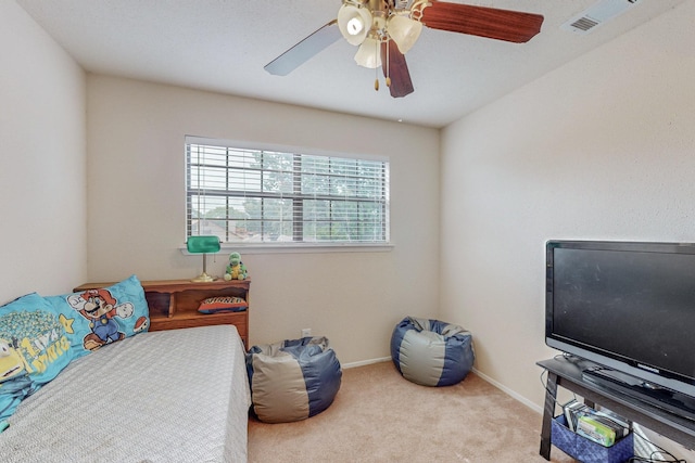 bedroom with ceiling fan and light carpet