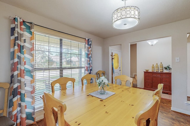 dining space with dark wood-type flooring