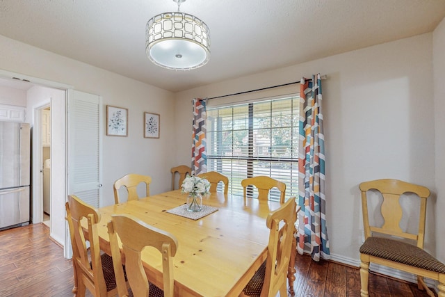 dining room with dark hardwood / wood-style flooring