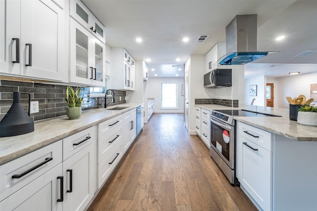 kitchen with stainless steel appliances, island exhaust hood, tasteful backsplash, dark wood-type flooring, and white cabinets