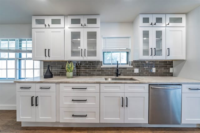 kitchen with dark hardwood / wood-style flooring, dishwasher, backsplash, white cabinetry, and sink