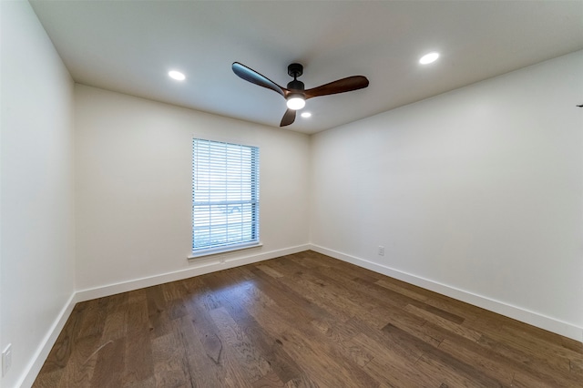 empty room with dark hardwood / wood-style flooring and ceiling fan