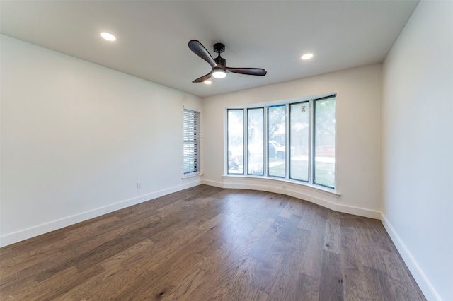 spare room featuring dark wood-type flooring and ceiling fan