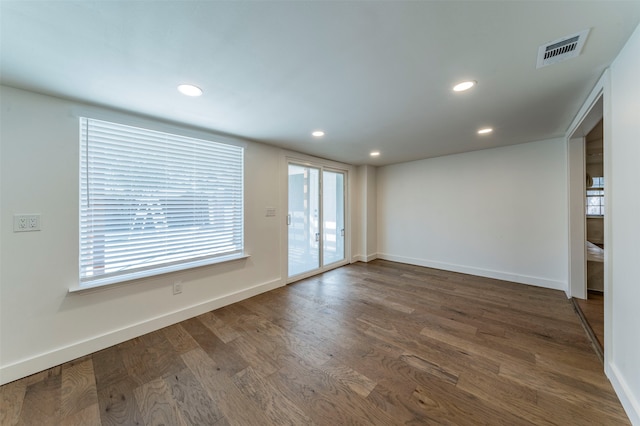 empty room with dark hardwood / wood-style flooring