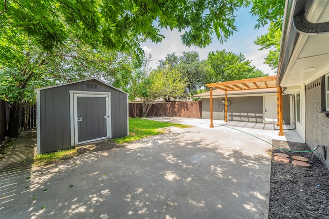 view of yard featuring a patio, a storage unit, and a pergola