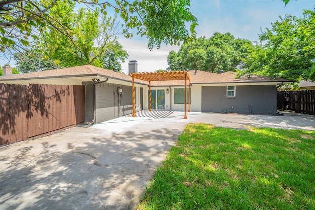 rear view of house featuring a patio area, a pergola, and a yard