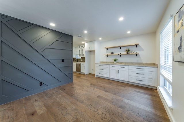 bathroom featuring a healthy amount of sunlight, hardwood / wood-style floors, and vanity