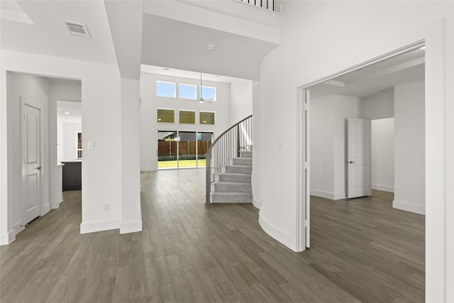 5241 Great Hollow Trl, Fort Worth, TX 76179 - unfurnished living room featuring stairway, dark wood finished floors, baseboards, and a towering ceiling