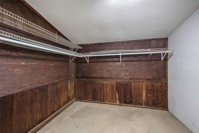 walk in closet featuring vaulted ceiling