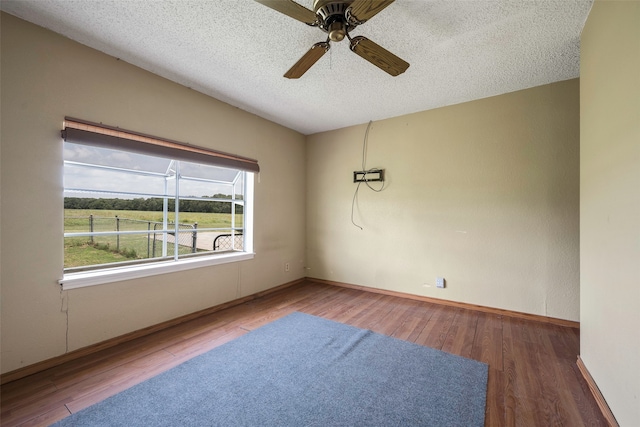 unfurnished room with wood-type flooring, ceiling fan, and a textured ceiling