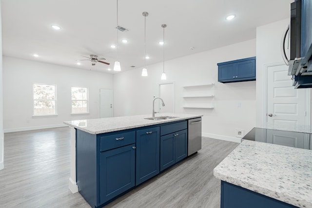 kitchen featuring stainless steel dishwasher, ceiling fan, sink, decorative light fixtures, and a center island with sink