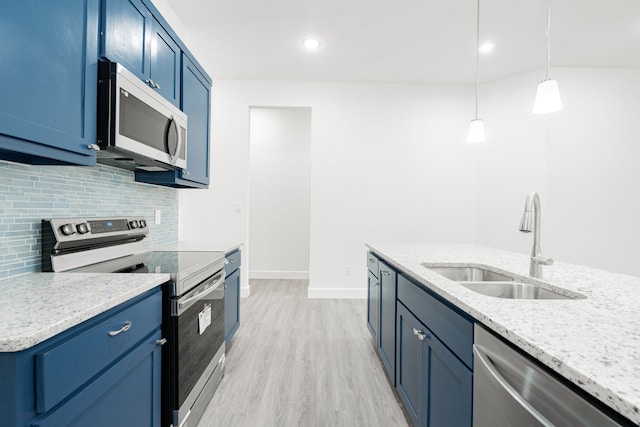 kitchen featuring appliances with stainless steel finishes, decorative light fixtures, light stone counters, and blue cabinets