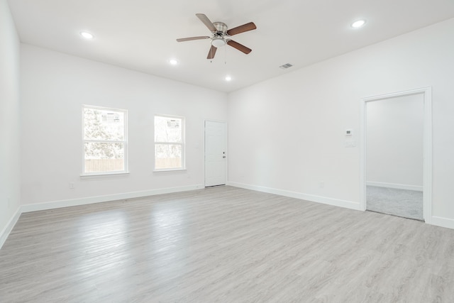 empty room featuring light wood-type flooring and ceiling fan