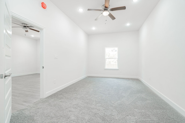 unfurnished room with ceiling fan and light carpet