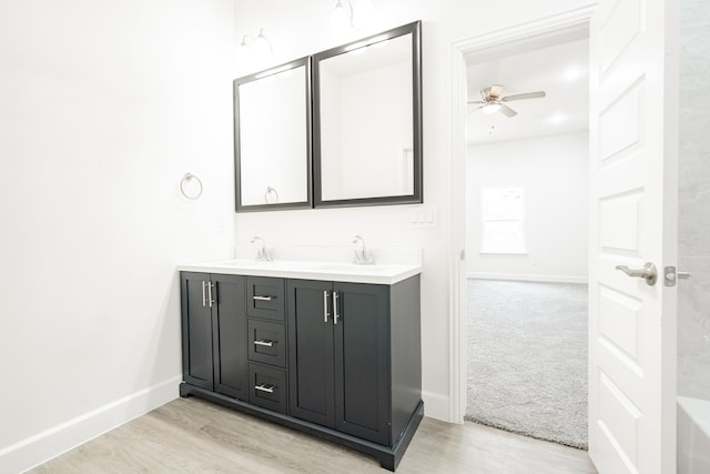 bathroom featuring hardwood / wood-style floors, vanity, and ceiling fan