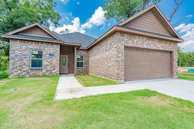 view of front of house with a garage and a front lawn