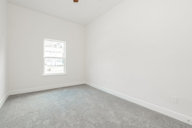 spare room featuring ceiling fan and carpet floors