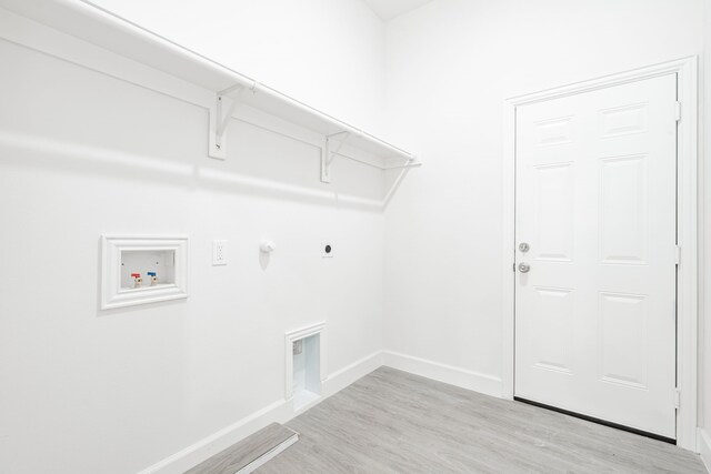 washroom featuring electric dryer hookup, gas dryer hookup, washer hookup, and light wood-type flooring