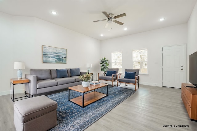 living room with light wood-type flooring and ceiling fan