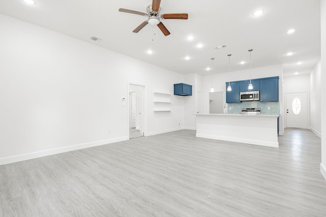 unfurnished living room with ceiling fan and light hardwood / wood-style flooring