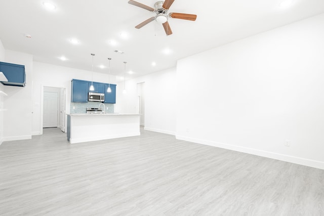 unfurnished living room featuring ceiling fan and light wood-type flooring