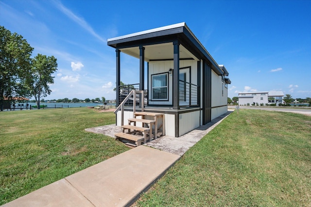 view of front of house featuring a front yard and a water view