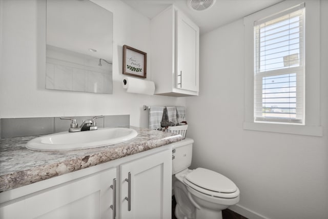 bathroom featuring vanity and toilet