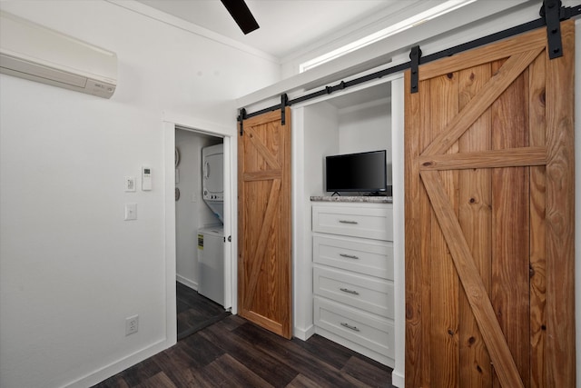 unfurnished bedroom featuring dark hardwood / wood-style flooring, an AC wall unit, ceiling fan, and a barn door