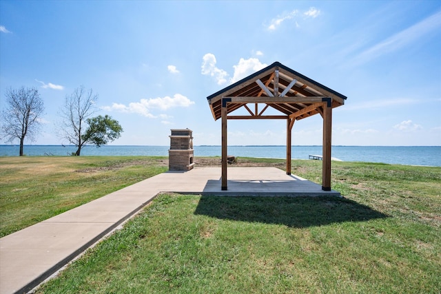 surrounding community featuring a gazebo, a water view, and a yard