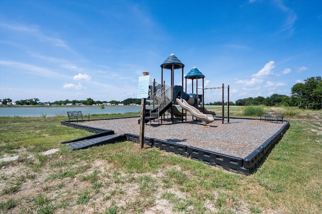 view of play area featuring a lawn and a water view