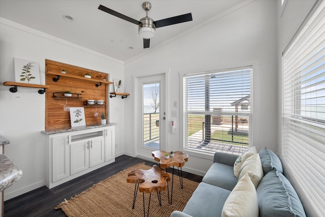 living room featuring crown molding, dark hardwood / wood-style floors, ceiling fan, and plenty of natural light