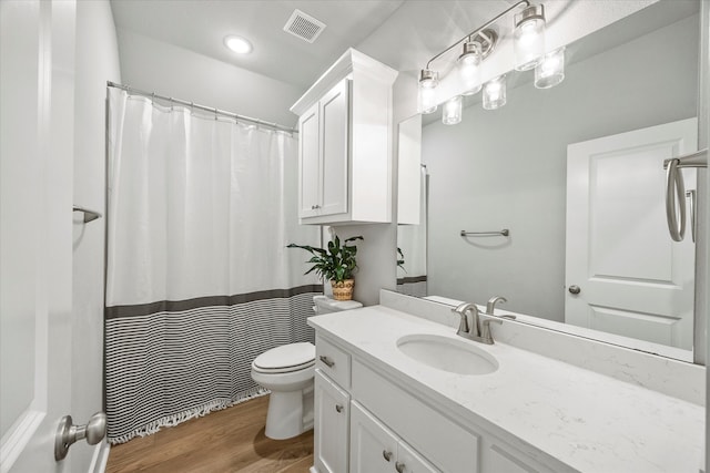 bathroom featuring hardwood / wood-style floors, vanity, and toilet