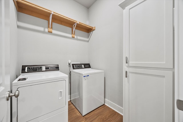 washroom with light hardwood / wood-style floors and separate washer and dryer