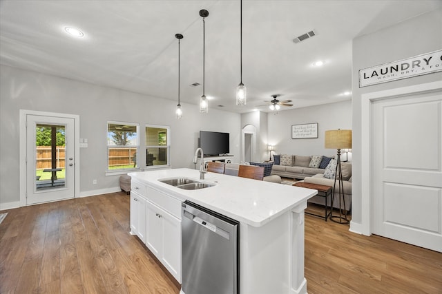 kitchen featuring stainless steel dishwasher, ceiling fan, a kitchen island with sink, sink, and white cabinetry