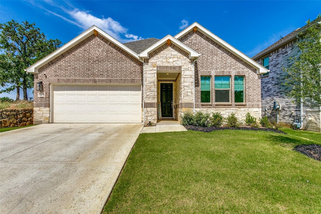 view of front of house with a garage and a front lawn