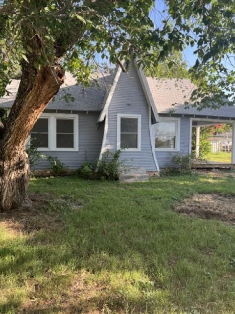 view of side of property with a lawn